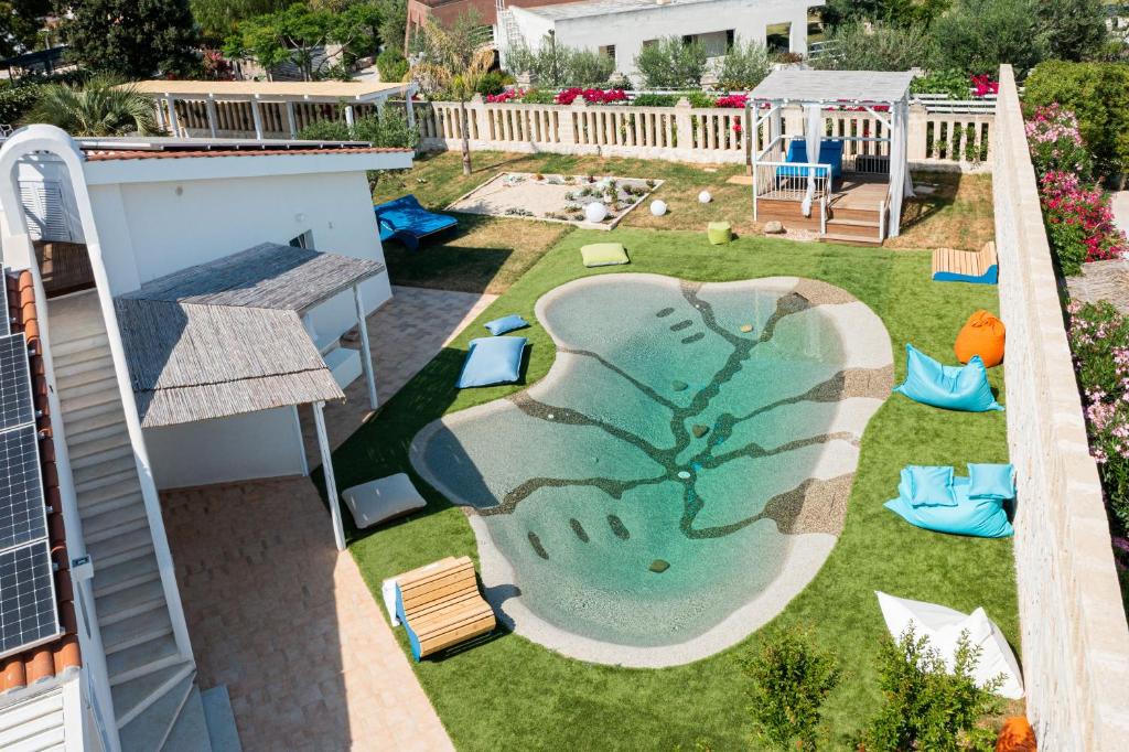 a backyard with a pool with a tree on it at Don Leonardo - pool and wellness in Polignano a Mare