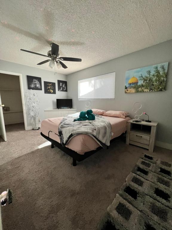 a bedroom with a bed and a ceiling fan at Sunshine Cabin in Crestline