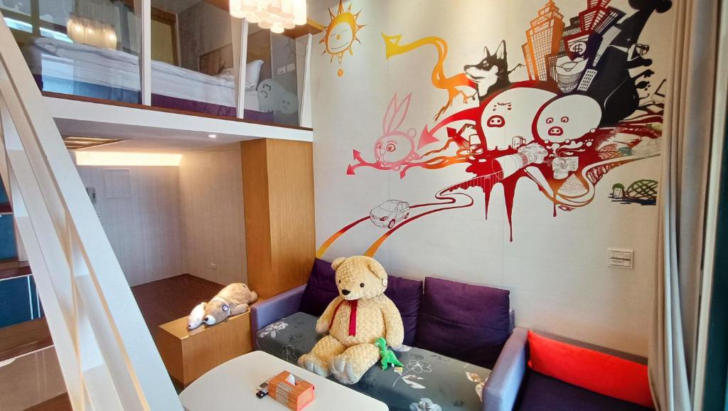 a room with two teddy bears sitting on a couch at 礁溪玥湯溫泉旅店 in Jiaoxi