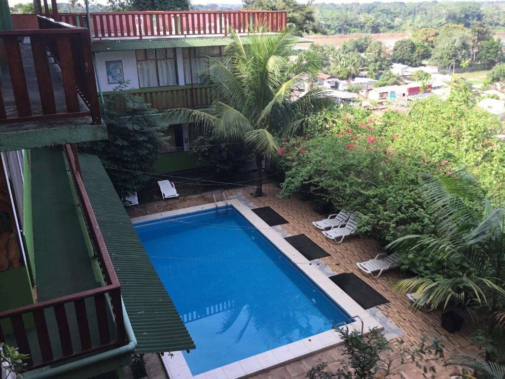 a view of a swimming pool from a balcony at Tambopata Hostel in Puerto Maldonado