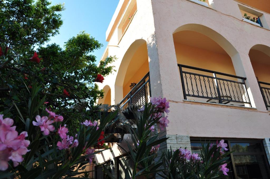 un edificio con balcón y flores delante de él en House Margot, en Palaikastro