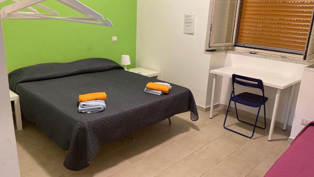 a bedroom with a bed and a table and a chair at CTA Catania Aeroporto fontanarossa reception h24 in Catania