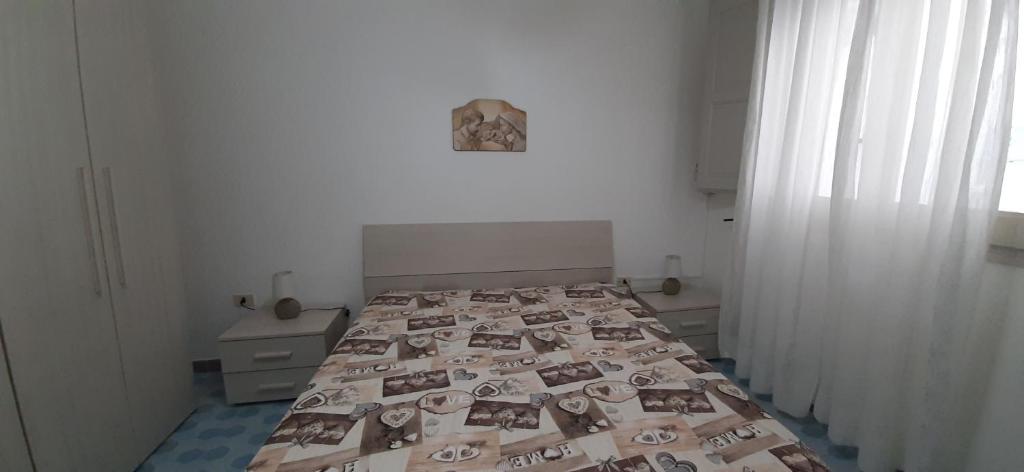 A bed or beds in a room at Casetta vicino alla spiaggia