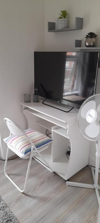 a white desk with a laptop and a chair at Blaney house 21 in Newcastle upon Tyne