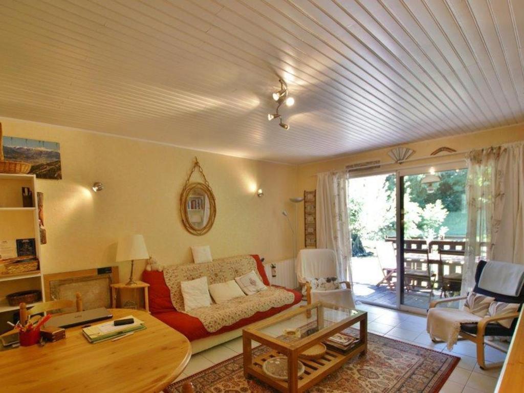 a living room with a couch and a table at Appartement Barcelonnette, 2 pièces, 6 personnes - FR-1-165A-19 in Barcelonnette