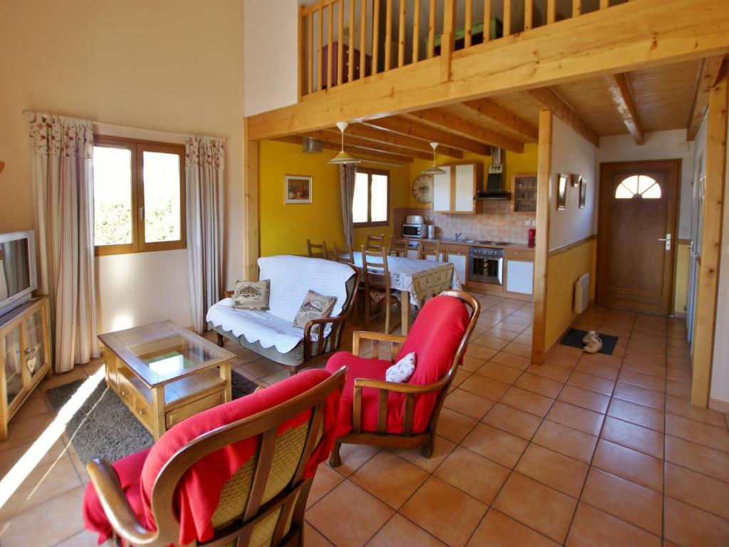 a living room with red chairs and a kitchen at Maison Saint-Pons, 4 pièces, 8 personnes - FR-1-165A-91 in Saint-Pons