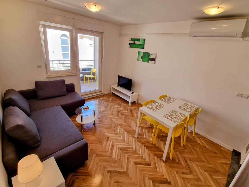 een woonkamer met een bank en een tafel bij Omiš City Apartment in Omiš