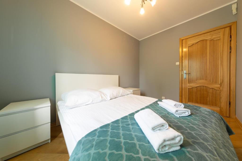 Posteľ alebo postele v izbe v ubytovaní Apartament z 3 sypialniami