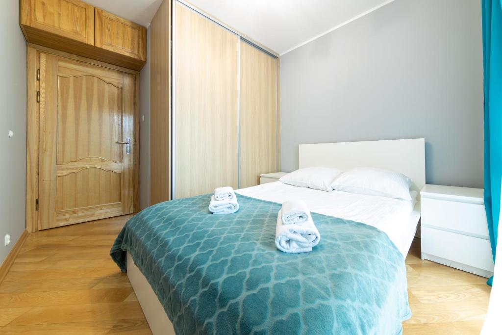 Posteľ alebo postele v izbe v ubytovaní Apartament z 3 sypialniami