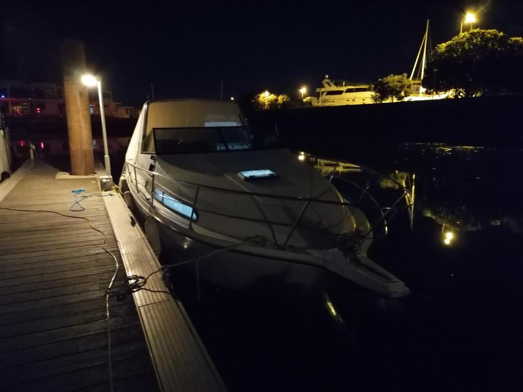 a boat is docked in the water at night at Séjour insolite sur un yacht. Bateau Hôtel à quai. in La Rochelle
