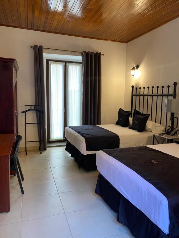 Postel nebo postele na pokoji v ubytování Hotel Plata Condesa