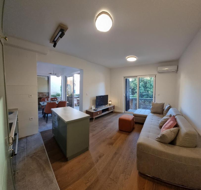 a living room with a couch and a table at Old town Apartments in Herceg-Novi