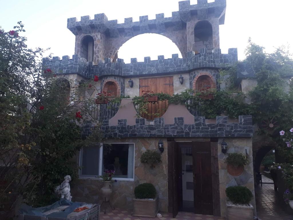 a building with a balcony on the side of it at Castel in Ciurbeşti