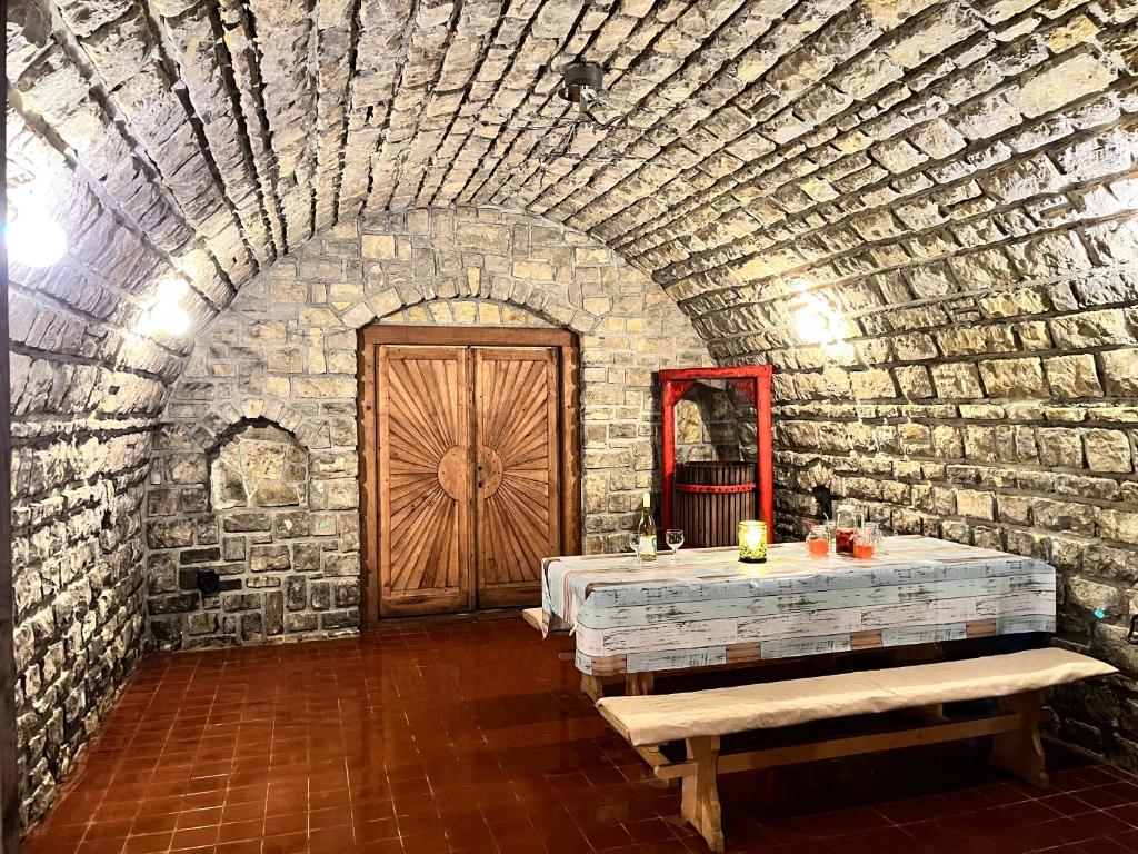 a room with a stone wall and a wooden door at Chill Apartman in Balatonfüred
