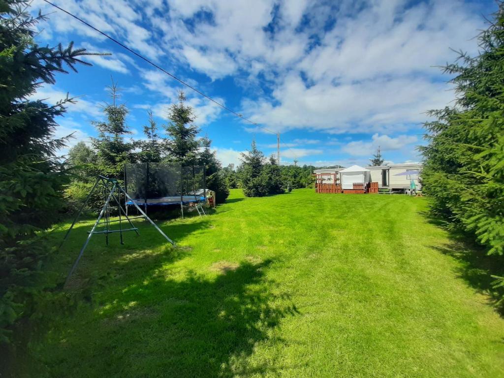 an image of a yard with a caravan at Agroturystyka u Rolnika - D Holender in Stare Nowakowo