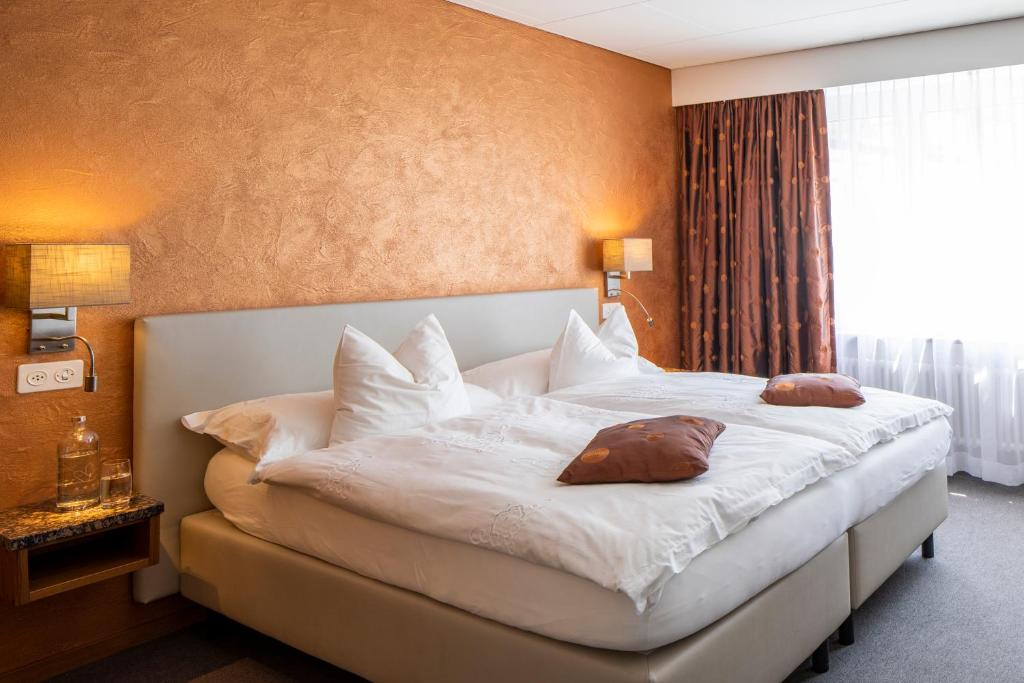 Postel nebo postele na pokoji v ubytování Cristallo Arosa Hotel