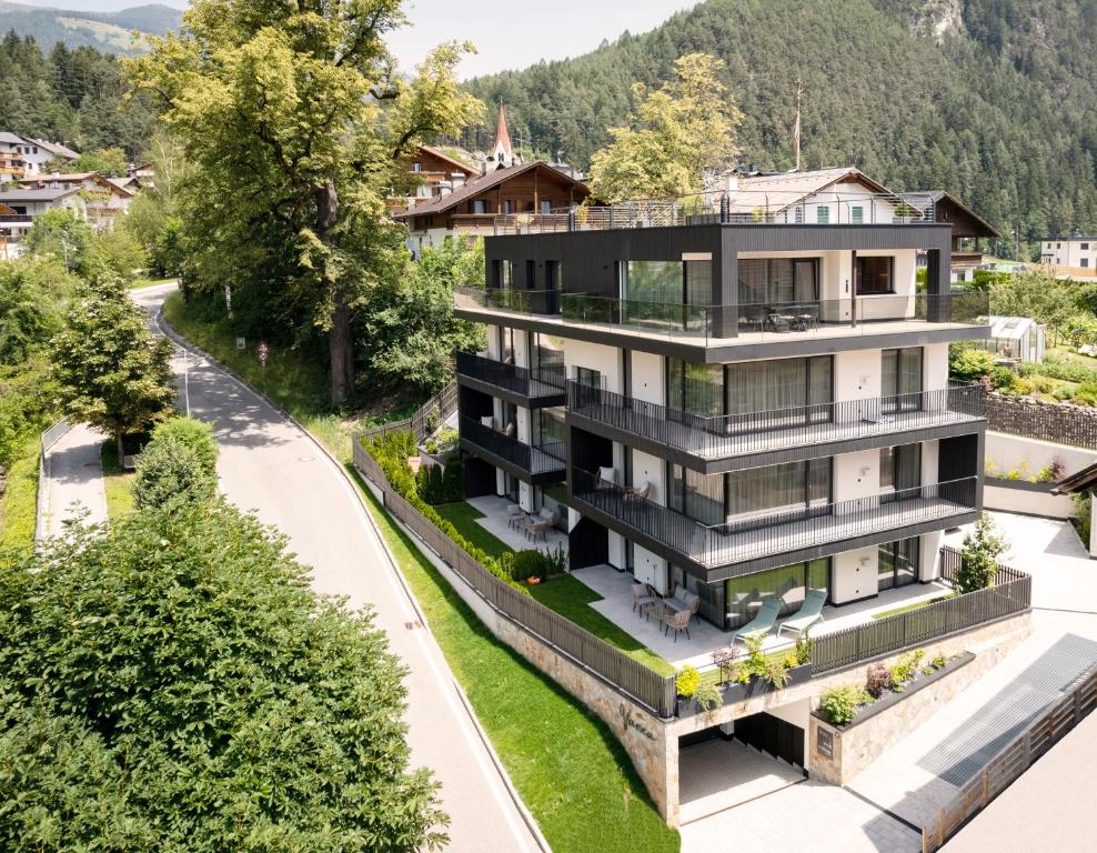 an aerial view of a house with trees at VANEA - Alp Relax Guesthouse in Chienes