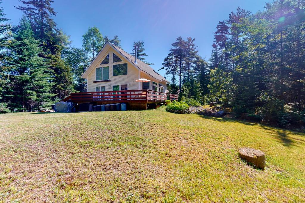 a large yard with a house in the background at Hidden Gem Retreat in East Boothbay