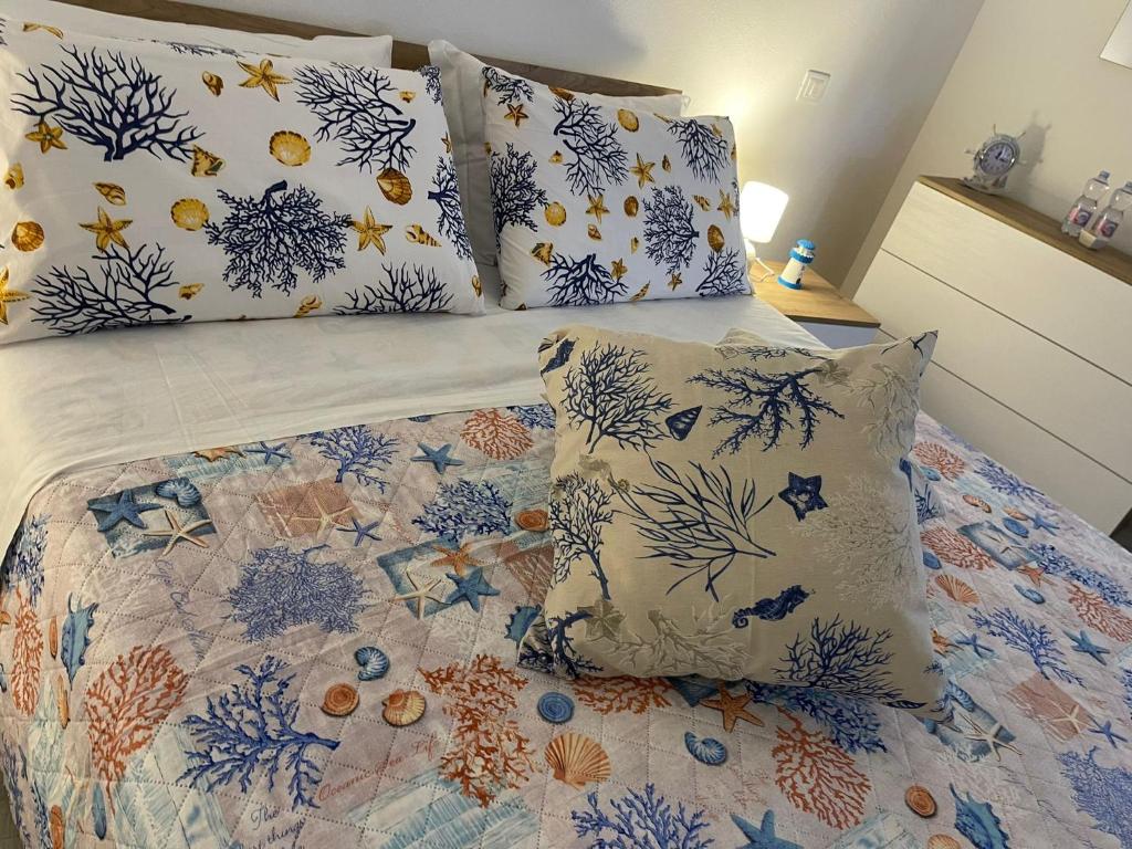 a bed with blue and white sheets and pillows at ANGEL ROOM in Cagliari