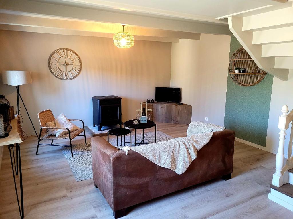 uma sala de estar com um sofá e uma mesa em Ti Fanch, maison proche de Quimper em Landudal