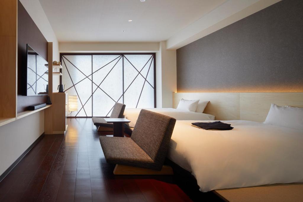 Postel nebo postele na pokoji v ubytování HOTEL AMANEK Kanazawa