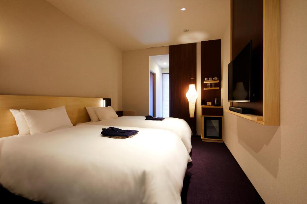 Postel nebo postele na pokoji v ubytování HOTEL AMANEK Kanazawa