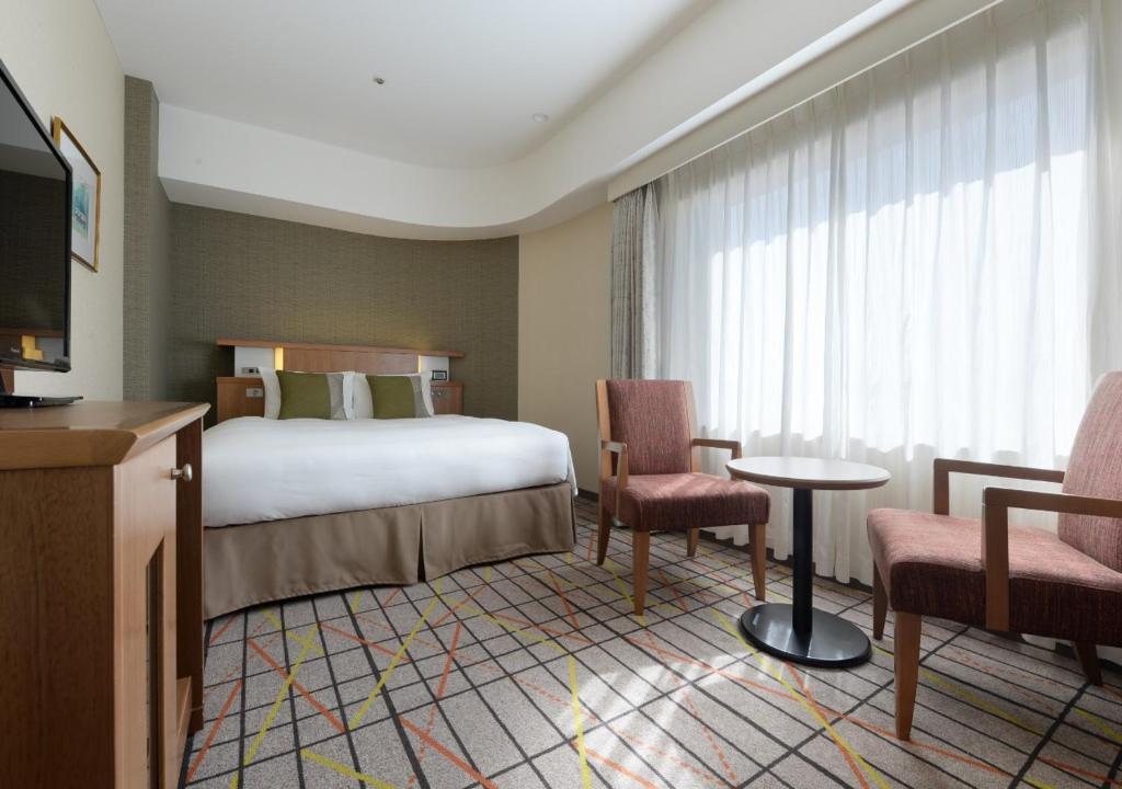 Postel nebo postele na pokoji v ubytování Hotel Metropolitan Tokyo Ikebukuro