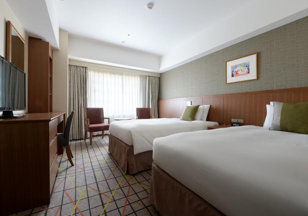Postel nebo postele na pokoji v ubytování Hotel Metropolitan Tokyo Ikebukuro