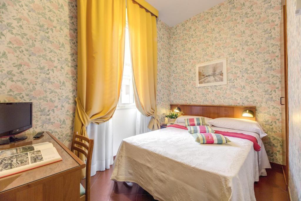 Postel nebo postele na pokoji v ubytování Hotel Corona