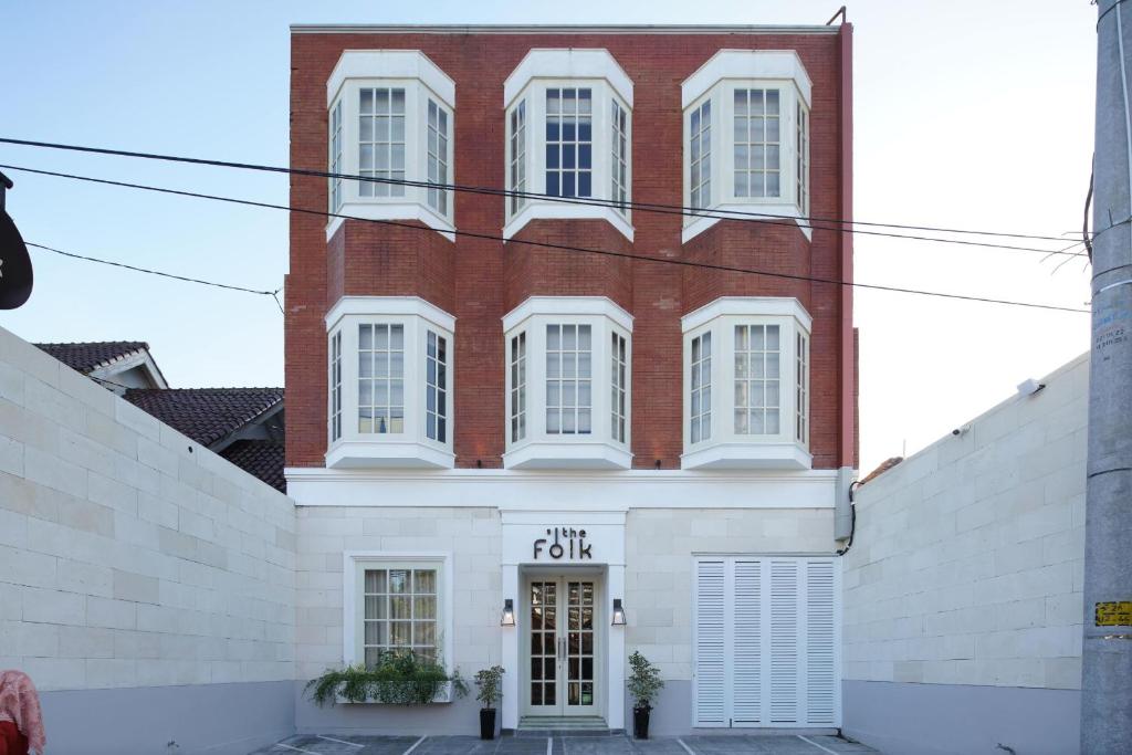 a large brick building with white windows at THE FOLK in Kejayan