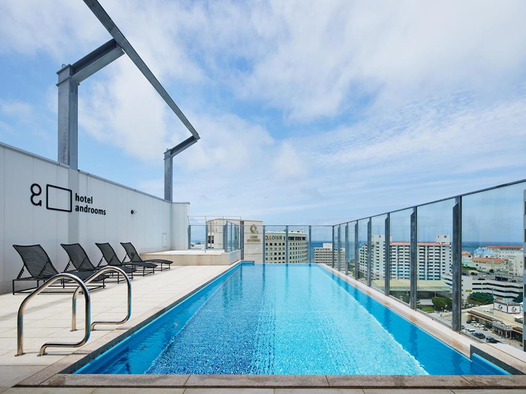 a swimming pool on the roof of a building at hotel androoms Naha Port in Naha