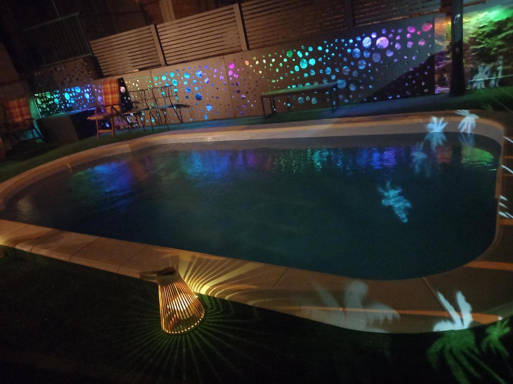 a swimming pool at night with lights at Apartmani Afrodita in Sutivan