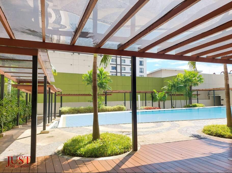 a view of a building with a swimming pool at King Size Bed At the Heart Of the City in Cagayan de Oro