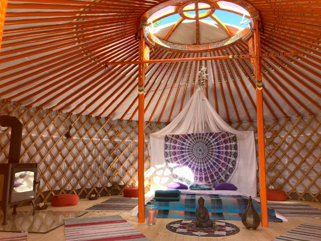 a yurt with a bed in it with a window at Jurta pod Blaníkem 