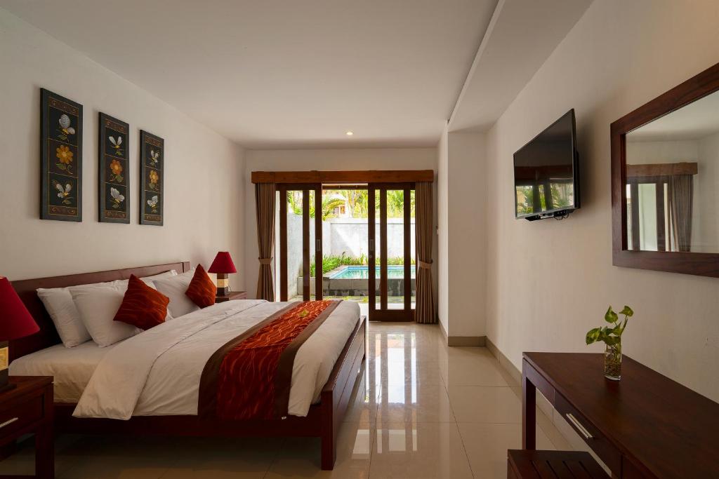 Postel nebo postele na pokoji v ubytování Kusuma Resort Seminyak