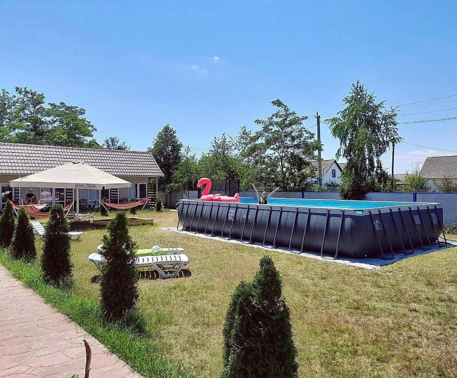 a backyard with a large inflatable pool and a playground at Буджак / Budjak in Primorskoye