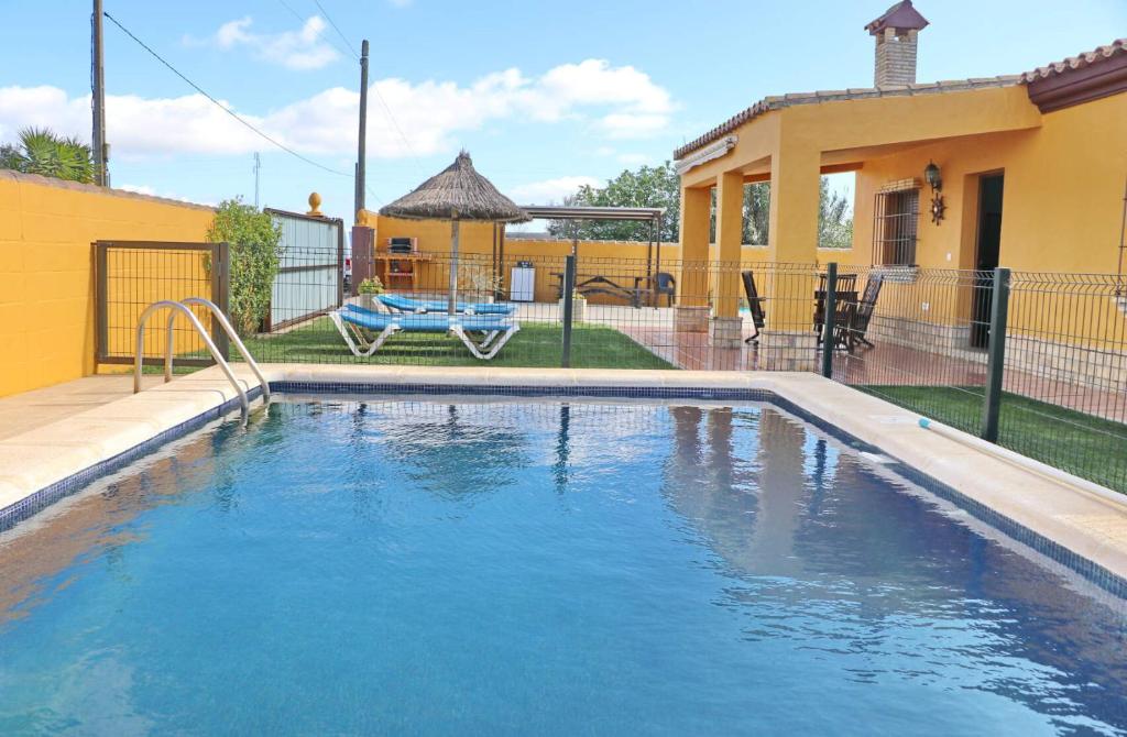 a swimming pool in the backyard of a house at Casa Calas Boliña in Roche