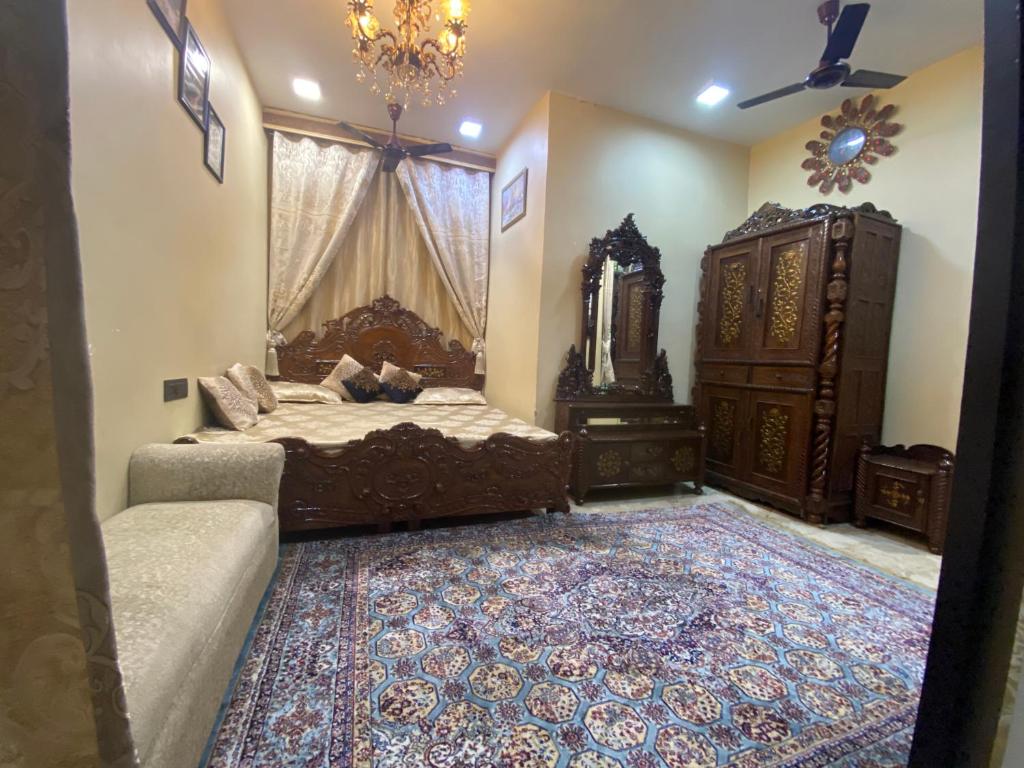 a bedroom with a bed and a dresser and a mirror at Sufi Khandar Home Stay in New Delhi
