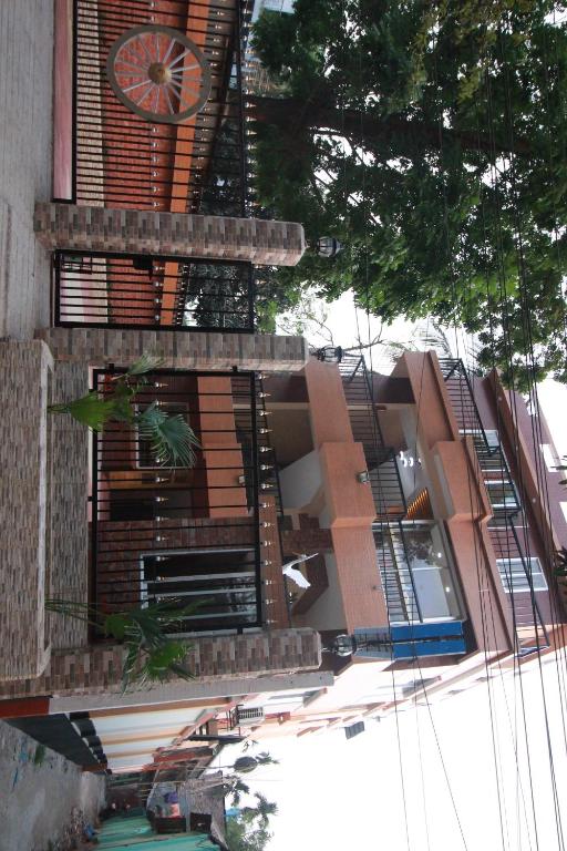 a building with a clock on the side of it at Little Rangpur Inn in Rangpur
