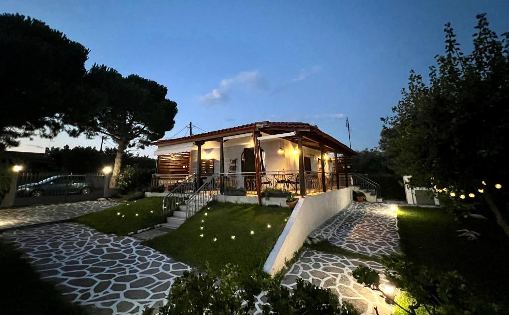 a house at night with a pathway leading to it at Anastasias Cottage in Nea Irakleia