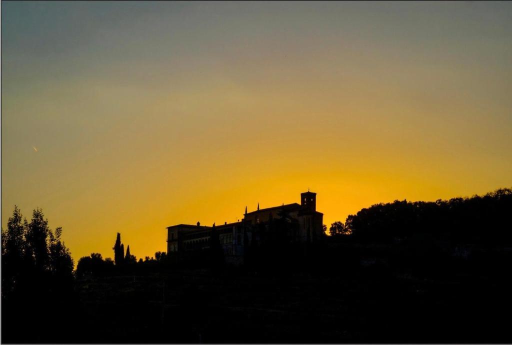 a silhouette of a building with the sunset in the background at Annunciata Soul Retreat in Coccaglio