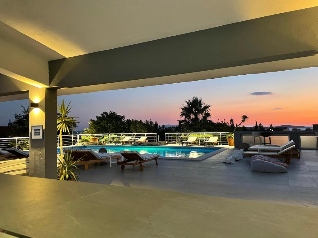 a house with a swimming pool on a roof at Dela in Hvar