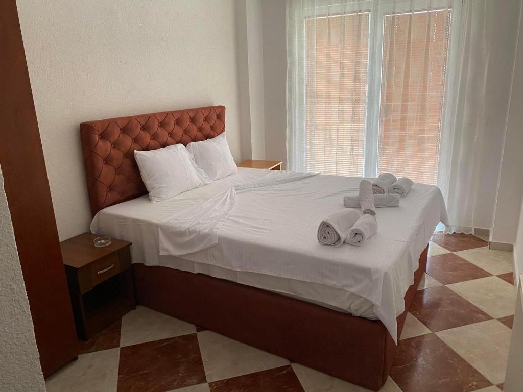 a bedroom with a large bed with towels on it at Hotel Montenegro in Struga