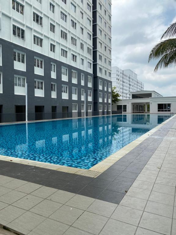 a large swimming pool in front of a building at Khadeeja Karisma in Semenyih