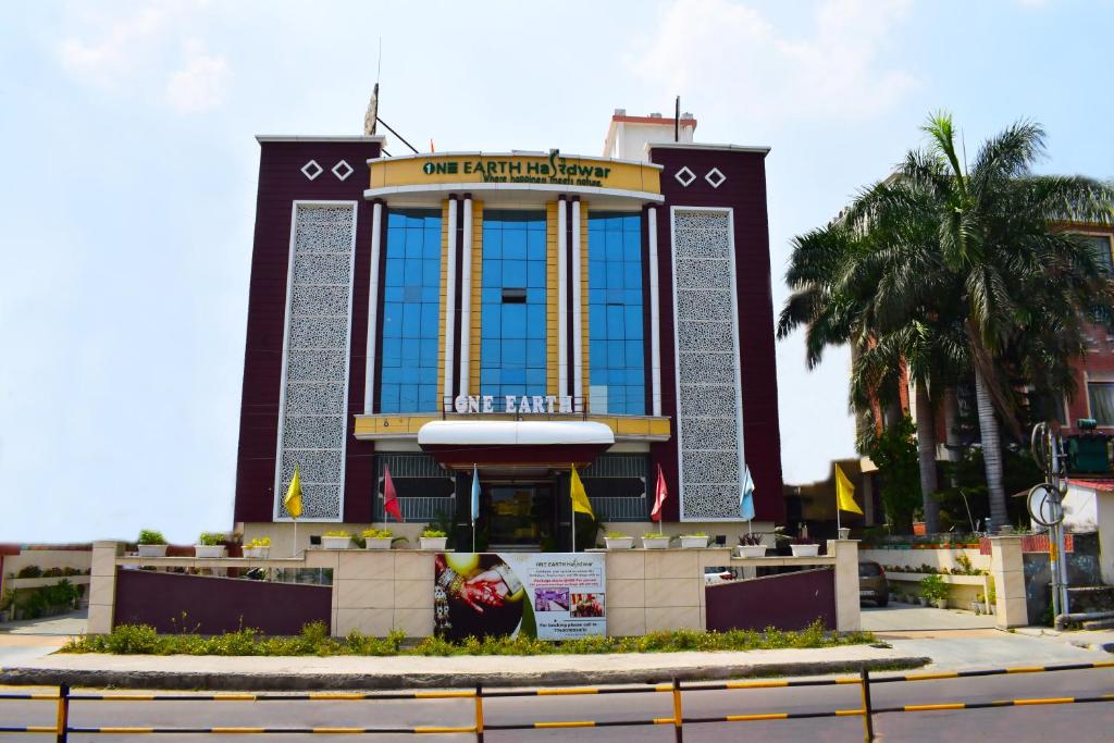 a large building with a sign in front of it at One Earth Hardwar in Haridwār
