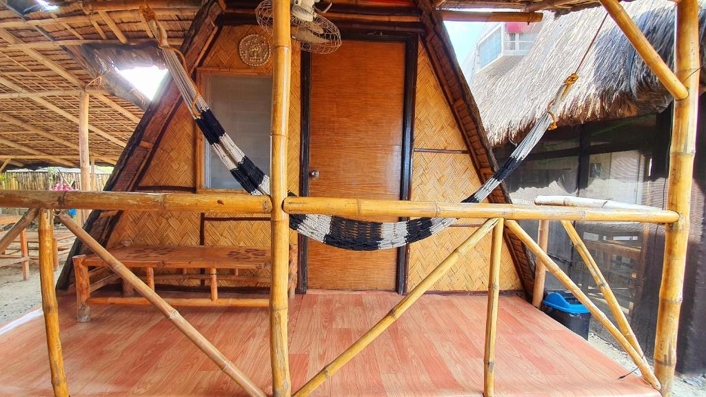 an inside view of a hut with a hammock in it at Calatagan's Bahay Kubo - with Beach Access in Batangas City