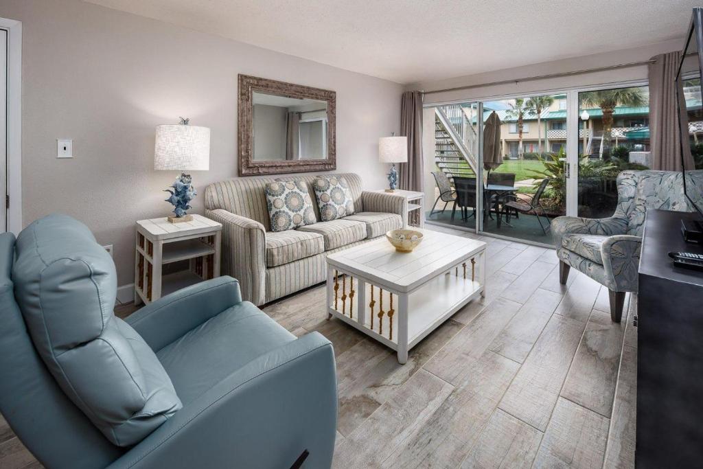 a living room with a couch and a table at Seaspray Condos 206B in Fort Walton Beach