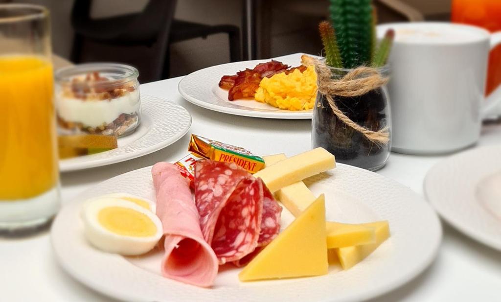 a white table with plates of food on it at Hôtel Amirauté in Toulon