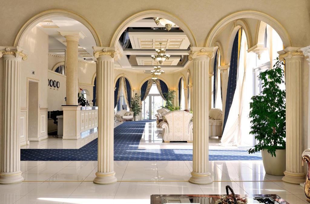 a large lobby with columns and a couch in a building at Park Hotel Stavropol in Stavropol