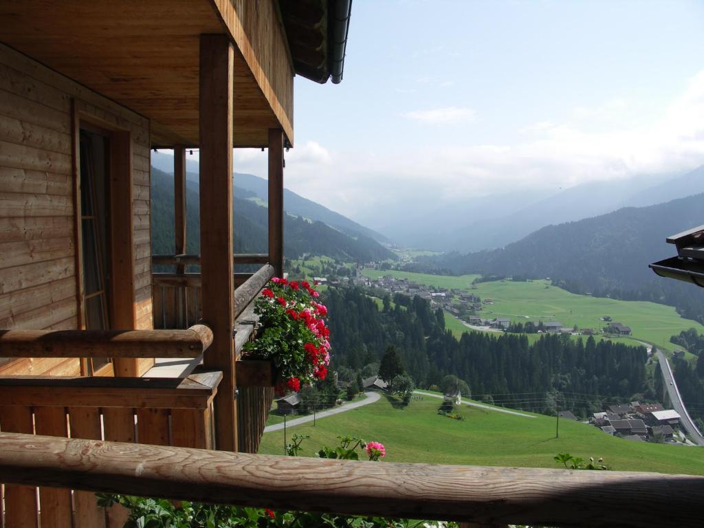 a view from the balcony of a house with flowers at Pension Oberhof in Sankt Lorenzen im Lesachtal